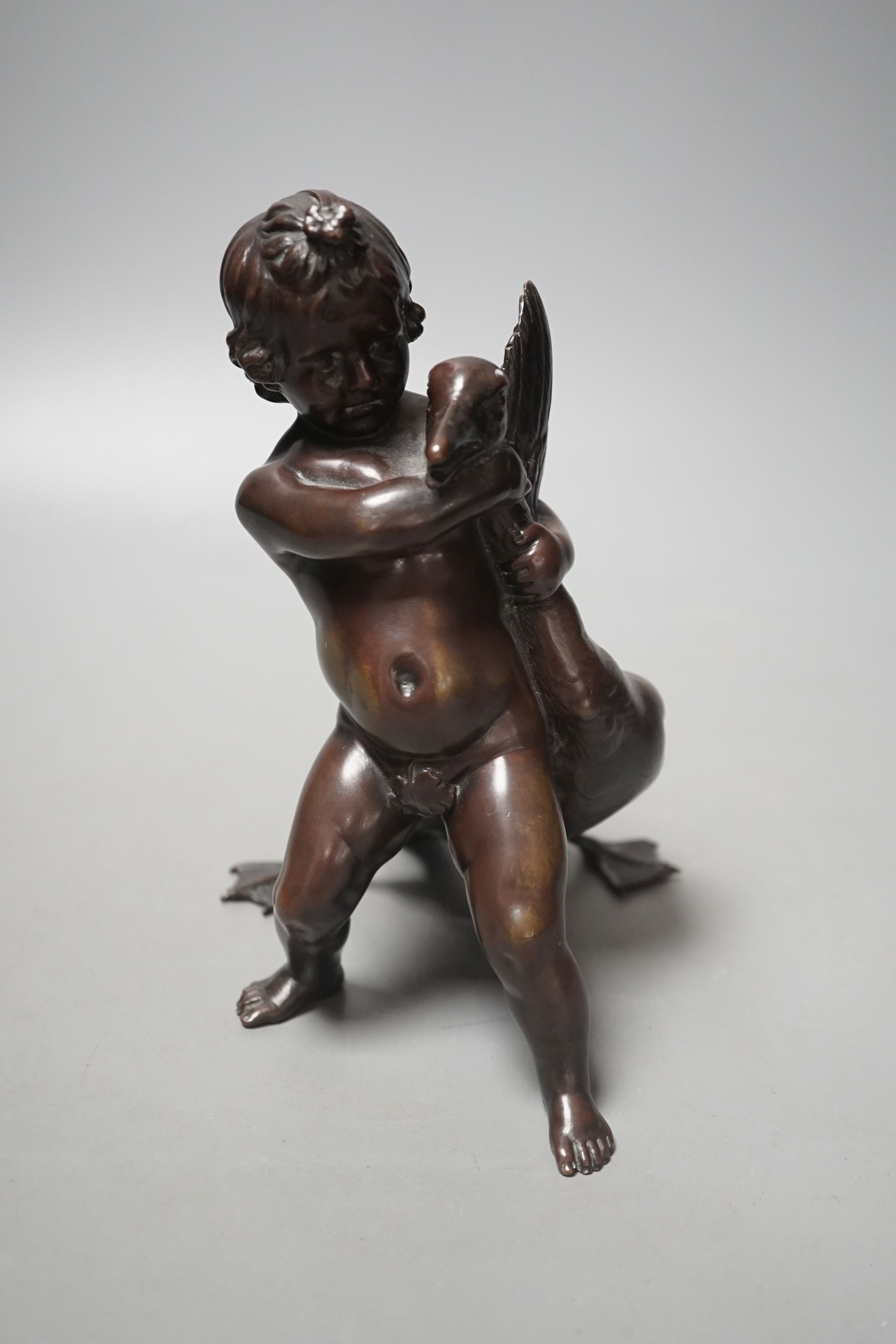 A Carl Karuba bronze of a cherub holding a goose, 17.5 cms high.